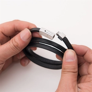 Detail view of double-wrap black leather bracelet with silver stainless steel clasp