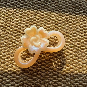 Detailed view of the pearlescent resin flower hair claw clip with a subtle shimmer finish