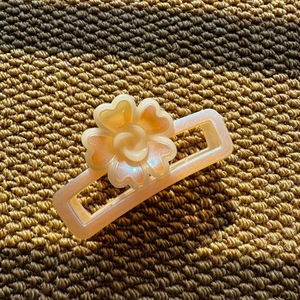 Macro shot of colorful resin flower hair claw with a pearlescent finish and rectangular design