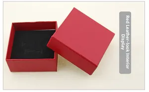 Macro shot of red faux leather jewelry box with black velvet lining and necklace slots