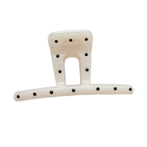 Polka dot hair claw clip in creamy white with black spots and sturdy metal spring