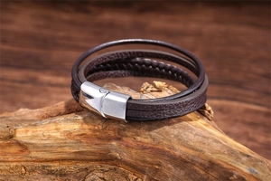 Detail of dark brown multilayer leather cord bracelet with silver magnetic steel clasp