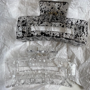 Detail of large ink-patterned and polka dot hair claws with sturdy metal spring mechanism