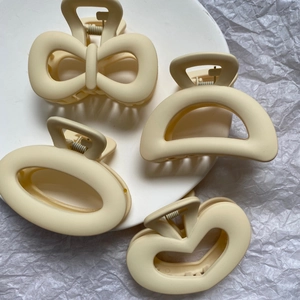 Elegant 4-piece cream matte hair claw clip set with bow, heart, and geometric shapes