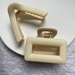 Matte creamy beige geometric hair claws in V-shape and rectangular hollow design