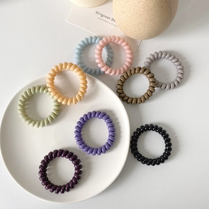 Set of 9 colorful spiral telephone wire hair ties in sweet macaron and earth tones