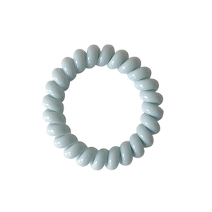 Pastel blue spiral telephone wire hair tie with a glossy finish and elastic design
