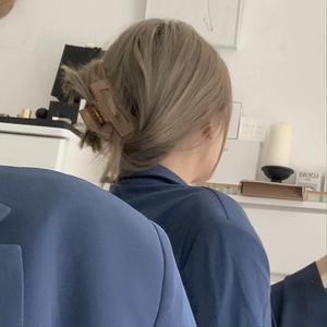 Brown rectangular resin hair claw clip shown in a practical French twist hairstyle