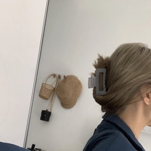 Matte grey square hair claw clip holding hair in a bun for casual everyday styling
