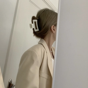 Elegant cream white square cutout hair claw clip shown in a stylish updo hairstyle