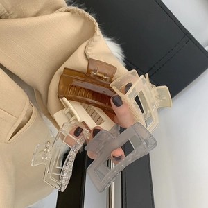 Close-up of elegant matte and transparent large hair claws in various stylish colors