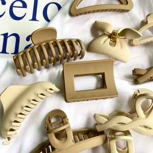Matte geometric hair claw clips in neutral beige and khaki tones for stylish hairstyling