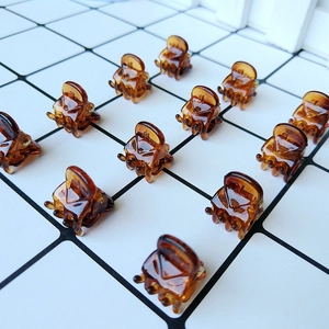 Macro detail of 1.5cm amber resin mini hair claws with tortoiseshell pattern set