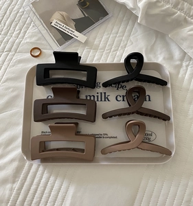Close-up of 6-piece matte hair claw set in black, chocolate, and milk tea shades