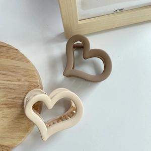 Matte heart-shaped hair claw clips in beige and brown colors for women, minimalist style