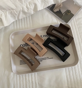 Set of four matte rectangular hair claws in earth tones beige khaki brown and black