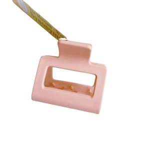 Elegant matte pink rectangular claw clip for hair with minimalist cutout design