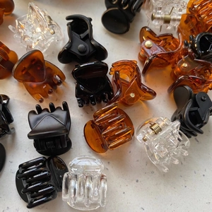 Mini 1.5cm teardrop hair clips in black, amber, and clear resin finishes for styling