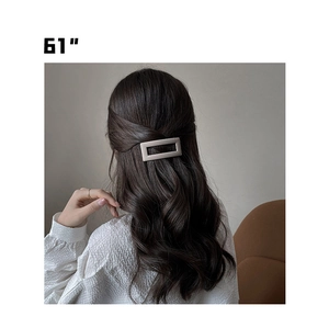 Detail view of champagne gold matte hair clip worn as an elegant back hair accessory