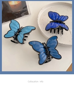 Detailed view of three blue butterfly hair claws in light, medium, and dark shades