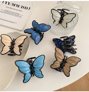 Detail of colorful butterfly hair claws in six colors on a decorative desk setting