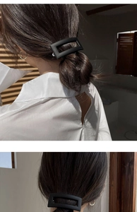 Close-up of matte black rectangular hair clip styled in a low ponytail updo hairstyle