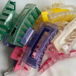 Macro shot of colorful plastic hair claws in various vibrant shades and rectangular shapes