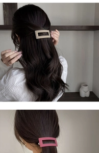 Detail of matte rectangular hair clips in beige and rose pink for elegant styling