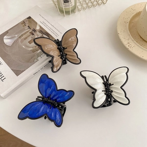 Three elegant glossy butterfly hair claws in blue, cream white and caramel brown colors