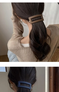 Detail of matte rectangular hair clips in brown and navy blue for elegant ponytail styles