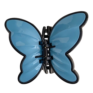 Elegant butterfly hair claw clip with blue wings and black frame on white background