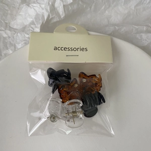 Close-up of mini jelly hair clips set in transparent and amber colors with card packaging
