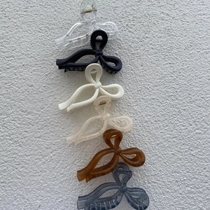 Set of six large bow hair claws in diverse colors like amber and white for elegant styling