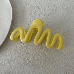 Dettaglio molletta per capelli ondulata 13cm giallo crema in resina lucida per capelli
