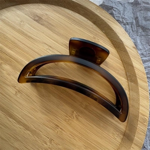 Macro view of a 12cm amber tortoiseshell hair claw clip for thick hair styling