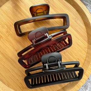Three-piece set of large rectangular hair claws in tortoiseshell and matte black finishes