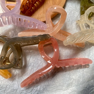 Assorted morandi jelly colors large shark hair clips on a wooden tray with soft textures