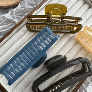 Detail view of large rectangular hollow hair claws in four elegant jelly colors