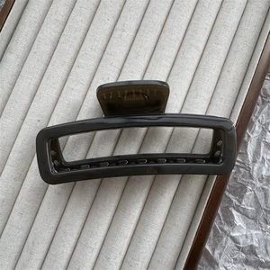 Detail view of large dark grey translucent rectangular hair claw clip for thick hair