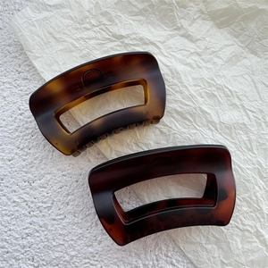 Elegant tortoise shell claw clips for thick hair featuring amber and dark brown textures