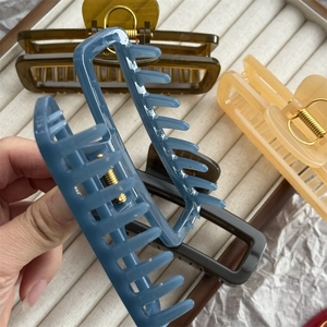 Close-up of matte rectangular hair claw clip showing durable spring and jelly colors