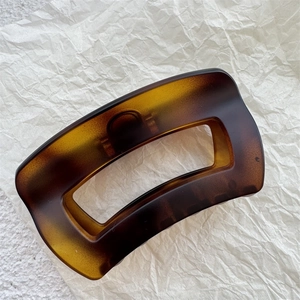 Close-up of amber tortoiseshell large hair claw clip with hollow rectangular design