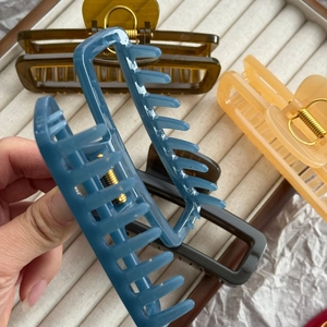 Set of large rectangular jelly color hair claws in blue, amber, and grey with gold springs