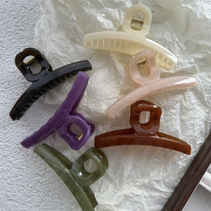 Close-up of assorted large jelly color hair claws in various elegant matte finishes