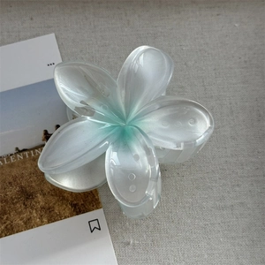 Détail de la pince à cheveux en forme de fleur bleu glacier translucide avec dégradé