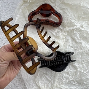 Matte finish large hollow hair claw clips in amber, tortoiseshell and black colors