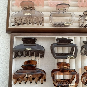 Detailed macro view of assorted square resin hair claws in tortoise shell and amber tones