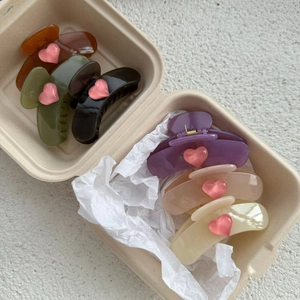 Close-up of heart hair claws in various jelly colors presented in a creative gift box