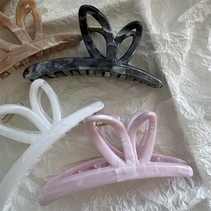 Elegant large butterfly hair claw clips in marble ink patterns and acetate texture