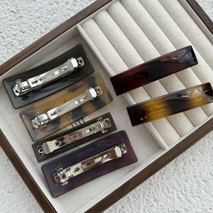 Rectangle acetate spring hair clips in various marble and tortoiseshell patterns for women